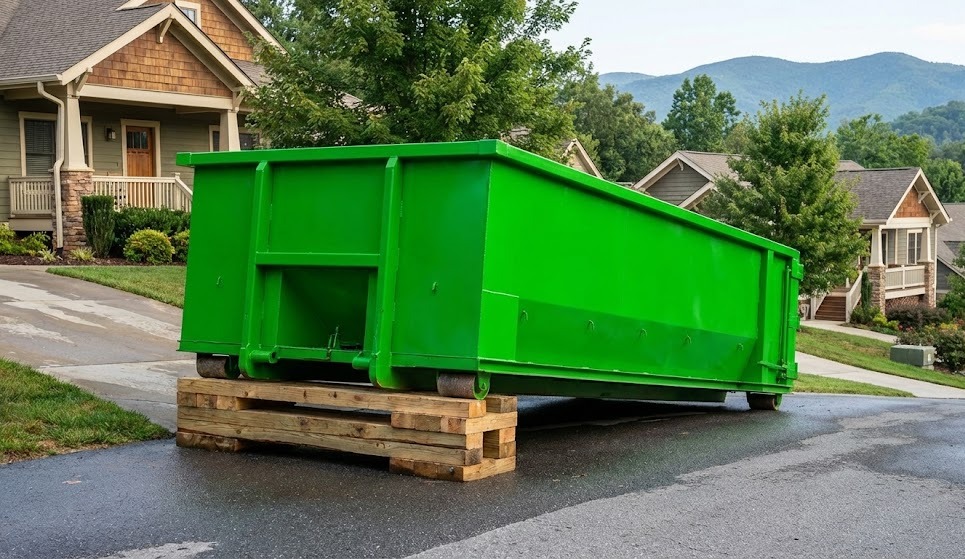 Dumpster safely levelled on an inclined driveway using wooden boards.